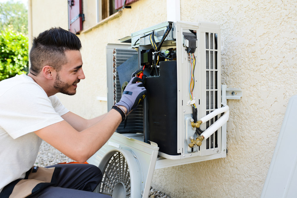 Professional Technician Repairing An Air Conditioning Unit